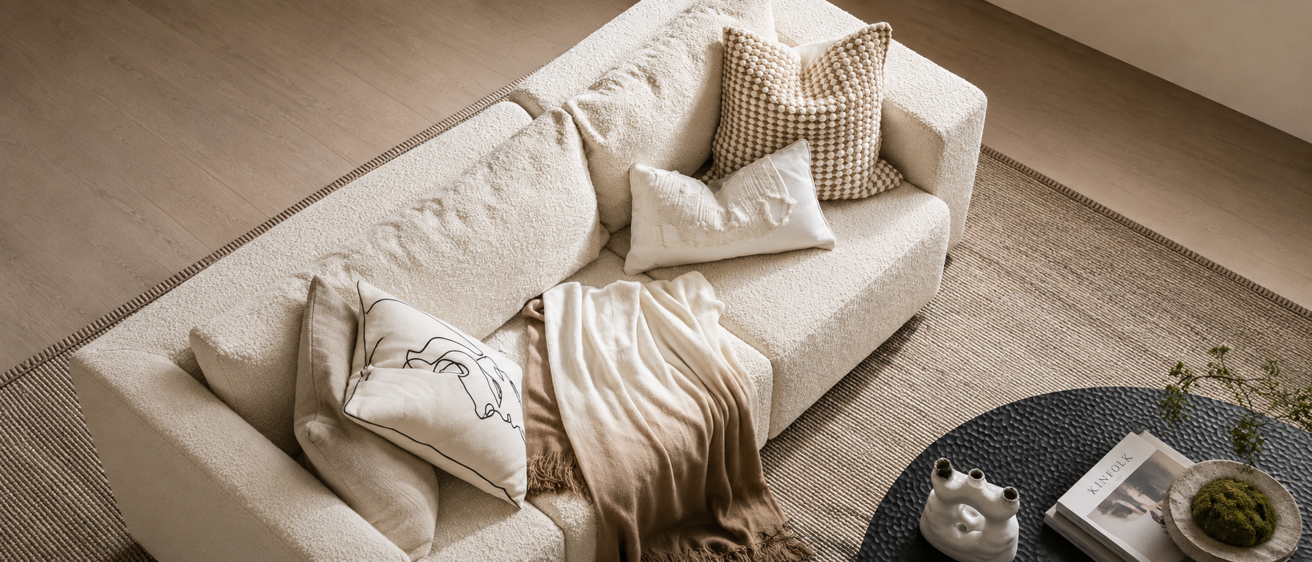Soft blankets and cushions styled in a warm living space