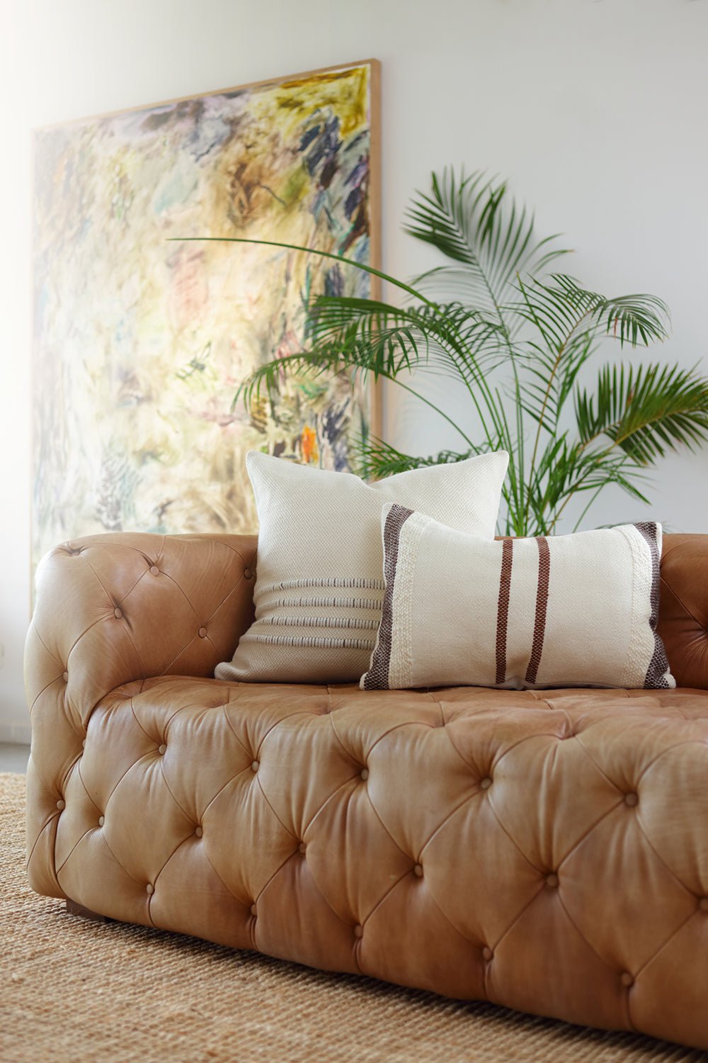 Layered cushions and throws in a warm interior